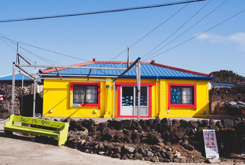 Yellow house with blue roof