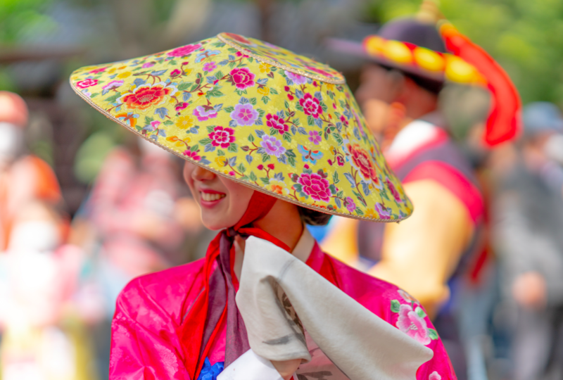 Woman in yellow flowered hat and pink dress